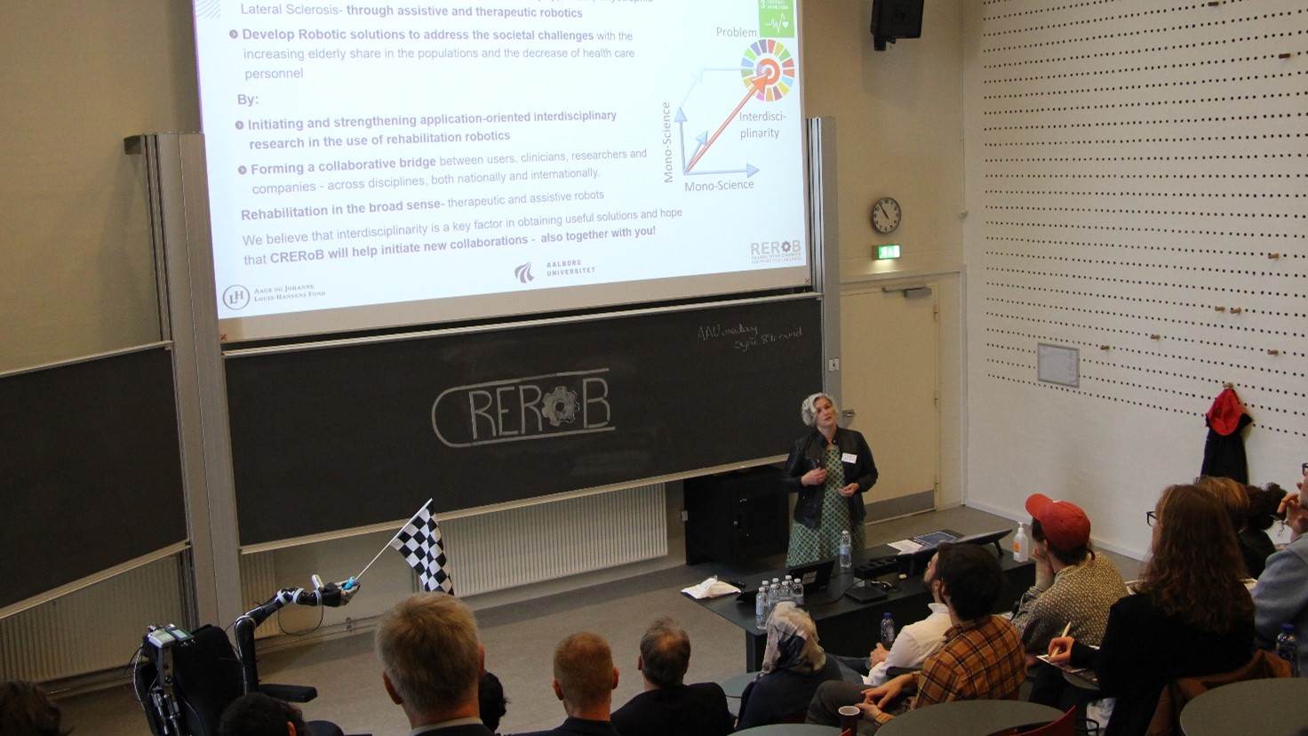 A photograph of the Head of Center, Lotte Struijk, giving her opening presentation at the opening seminar for the Center of Rehabilitation Robotics.